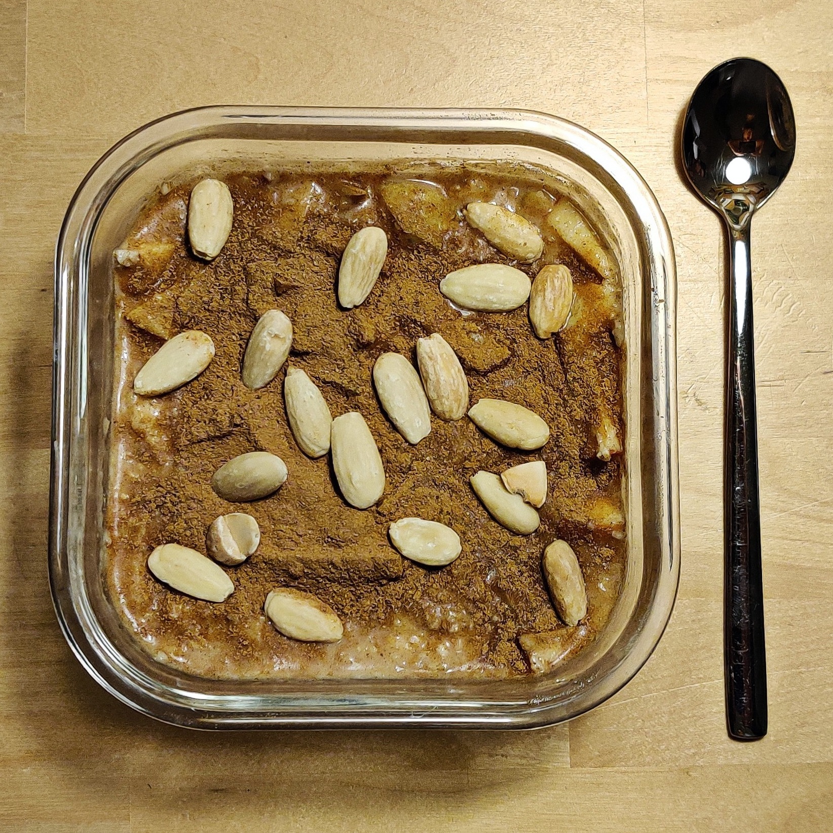 A container filled with protein oats and a spoon on the side